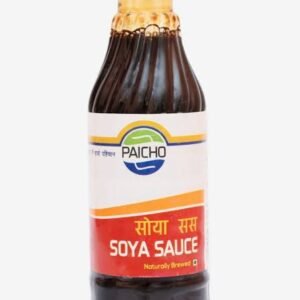 A plastic bottle of Paicho Soya Sauce filled with dark sauce, featuring a green cap and a white and red label with English and Nepali text.