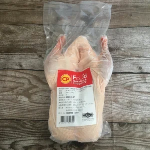Front view of a clear plastic bag containing a whole frozen duck, featuring a large red CP Food Service & Industry label with a Japanese specification chart and a Halal logo at the bottom right.